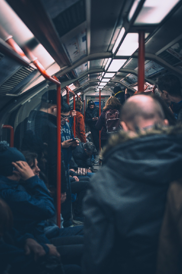 People burying their heads in devices on metros